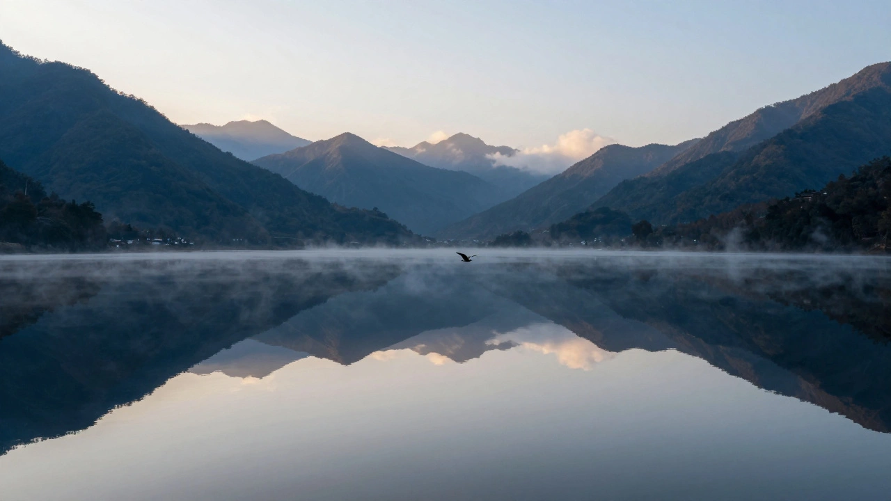 A centered horizon reflecting mountains in a calm lake at dawn, with a bird breaking the symmetry.
