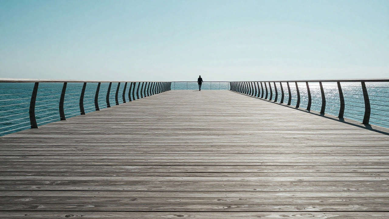 A long pier with leading lines converging toward a person standing on the horizon.