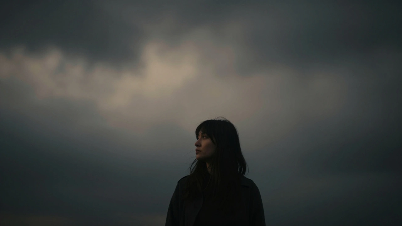 Off-center portrait of a person against a blurred, dark, minimalist background.
