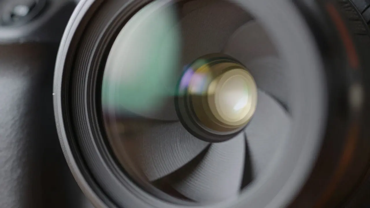 Close-up of camera lens aperture blades open