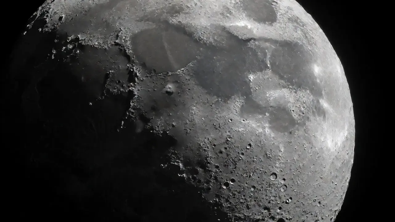 Detailed close-up of the Moon's surface showing craters and long shadows