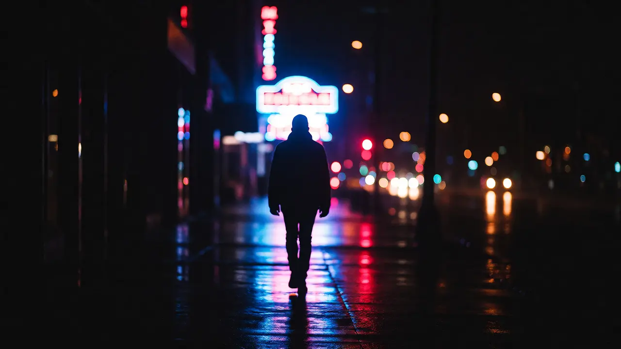 Night street scene with a figure outlined by neon backlighting