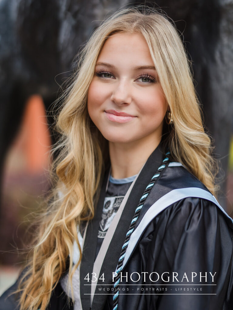 An oviedo Senior portrait session of a girl in a cap and gown in oveido florida