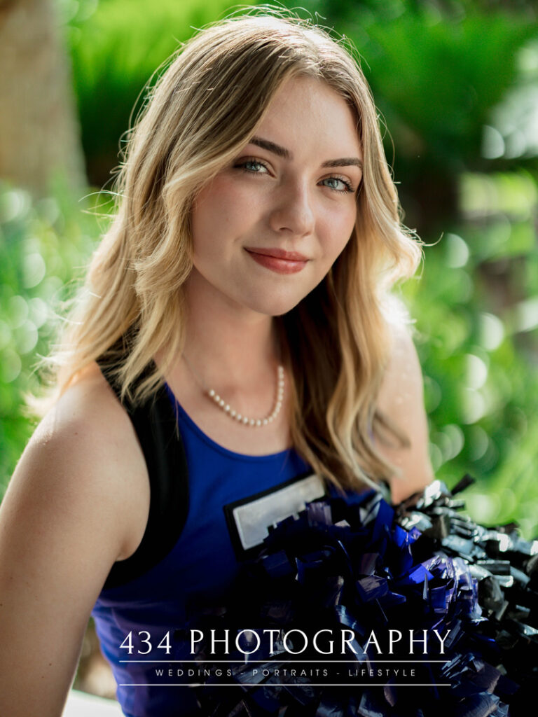 a high school senior in a cheerleading outfit.