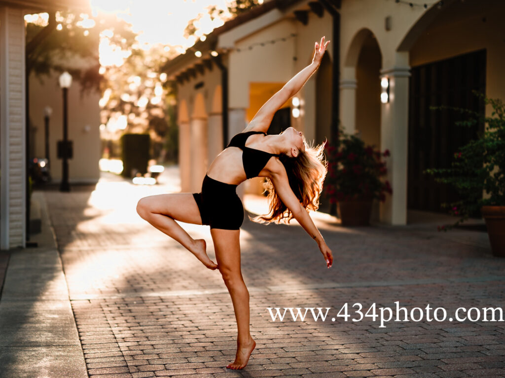 a senior dancing with sun behind her