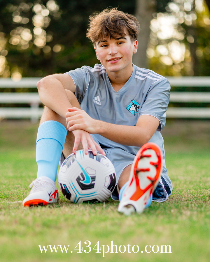 high school senior portrait with a soccer player