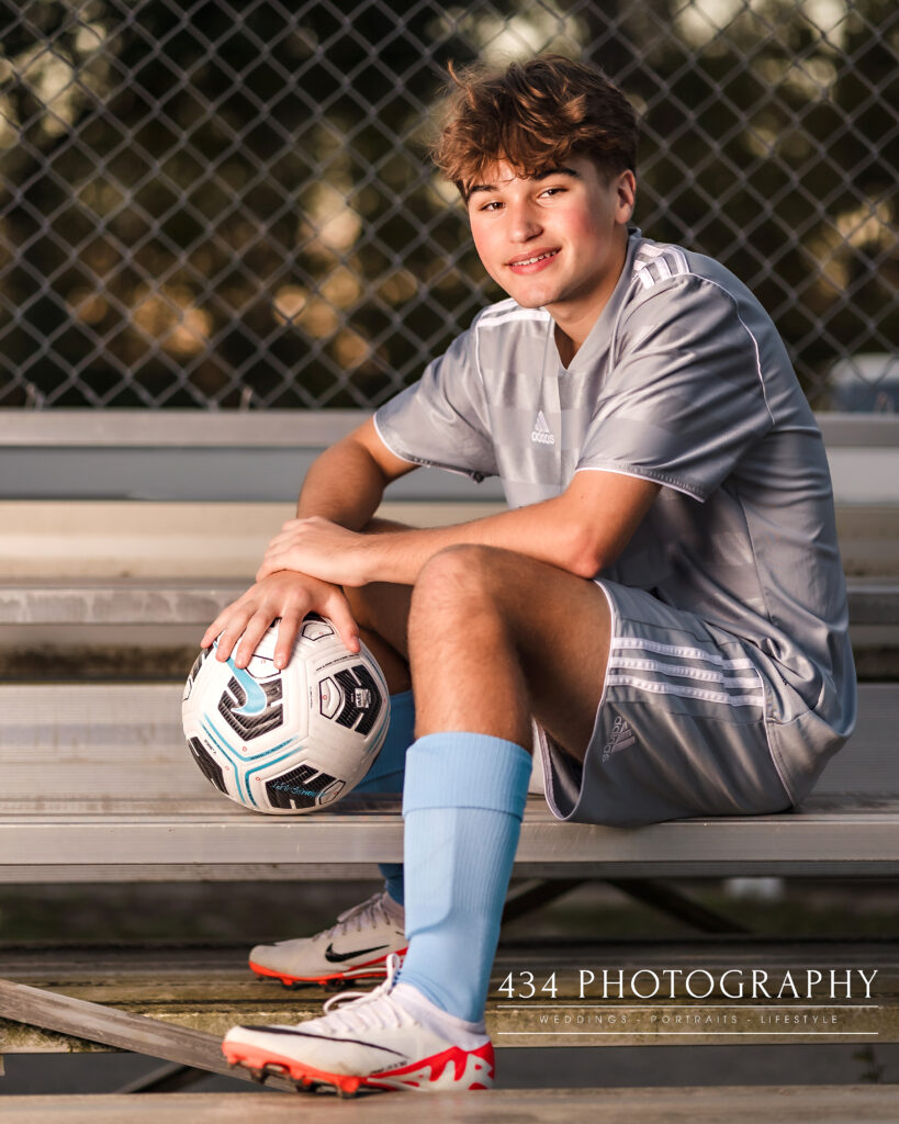 A High school senior soccer player on bleachers